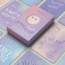 Eine geschlossene Schachtel MYGA Teenage Affirmation Cards umgeben von mehreren hellblau-lila verlaufenden Karten mit positiven Botschaften wie „acceptance is FREEDOM“ und „LANGUAGE IS POWER“.