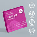 Eine magentafarbene Schachtel Harmonify Pfefferminz-Kaugummi mit Koffein (9 Stück), hervorgehoben durch Symbole für vegan, glutenfrei, GVO-frei und zuckerfrei auf einem grauen Hintergrund.