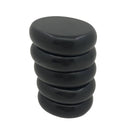 A vertical stack of five smooth, oval, black basalt stones for a hot stone massage, set against a white background.