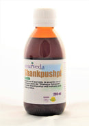  Eine braune Glasflasche mit weißem Schraubverschluss, beschriftet mit "Ayurveda autentico Shankhpushpi Aceite". Das Etikett besagt, dass es auf Ayurveda und "Bhaisajya Ratnawali" basiert, für Babys und Kinder ("bebes y niños") angezeigt ist, und zeigt "200 ml" und "100% Natur" mit einem Affen-Symbol.