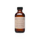 Eine Nahaufnahme des rückseitigen Etiketts der PAAVANI Spiced Cinnamon Oil Pulling Ölflasche, mit detaillierten Gebrauchsanweisungen und einer Liste der Inhaltsstoffe, darunter Sesamöl, Kokosnussöl, Kurkuma und verschiedene ätherische Öle.