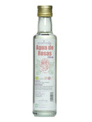 Eine durchsichtige Glasflasche Ayurveda Rosenwasser, 250 ml, mit einer Rosenillustration und Details auf Spanisch über seinen biologischen Charakter und die Verwendung.