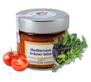 Glas „Mediterrane Kräuter Salsa“ mit silbernem Deckel, Aufschrift „Edition Gold“. Umgeben von frischen Tomaten und Kräutern, die eine frische, würzige Essenz vermitteln.