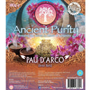 Ein brauner Papierbeutel mit "Ancient Purity Pau D'arco (Inner Bark)" und einem farbenfrohen Etikett, das einen alten Maya- oder Aztekenkalender und rosa Blumen zeigt.