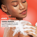 Eine lächelnde Dame mit strahlender Haut trägt schaumige Seife auf ihre Schulter auf. Der Text lautet „Bright and Shine“ und verspricht sichtbare Ergebnisse in 2–3 Wochen.