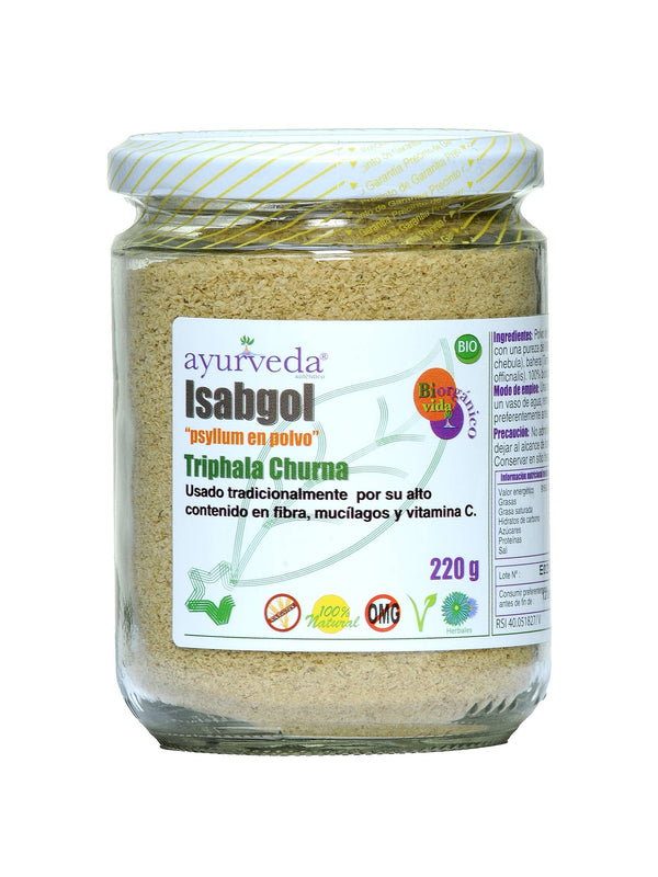  Ein Glasgefäß mit gelb-weiß gestreiftem Deckel enthält "Ayurveda autentico Isabgol" (Flohsamen in Pulverform) "Triphala Churna". Das Etikett zeigt "220 g", "BIO", "100% Natur", "Sin Gluten" und "OMG" (gentechnikfrei) Symbole.