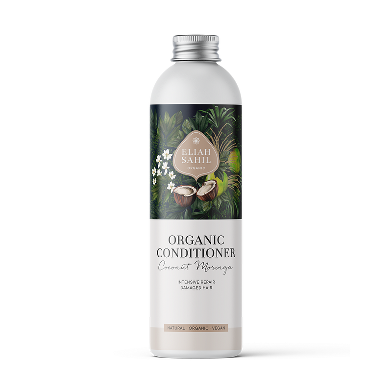 Produktfoto einer weißen Flasche „Eliah Sahil Organic Conditioner Coconut Moringa“ mit einem dunklen Etikett im Naturthema, das Kokosnüsse und grüne Blätter zeigt und intensive Reparatur für geschädigtes Haar verspricht.