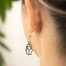 Hamsa earrings with lotus and Om – symbolism and style combined