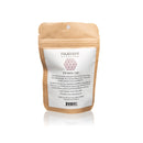 Eine braune Papiertüte für den Paavani Eye Wash Cup, die die ayurvedischen Empfehlungen und Anwendungsanweisungen zum Waschen der Augen mit Blumenwasser zur Reduzierung von Augenringen und zur Revitalisierung der Augen enthält.