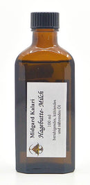 Auf der braunen Glasflasche mit weißem Etikett steht der Text „Midgard Kalari Hagebutte-Milch Thailam, 100 ml“. Das Etikett zeigt das Bild einer Hagebutte und verbindet ayurvedische Elemente mit den beruhigenden Eigenschaften der Hagebutte-Milch.